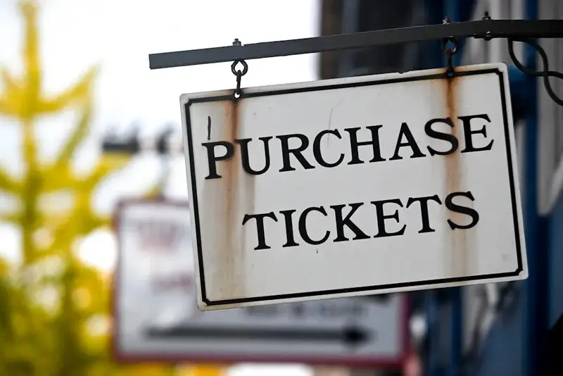 Close-up of a vintage 'Purchase Tickets' sign in Covington, Kentucky.